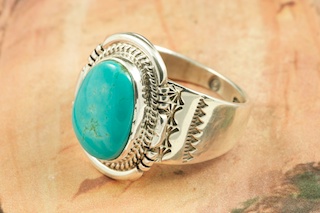 Genuine Manassa Turquoise set in Sterling Silver Ring. This Turquoise is also referred to as King�s Manassa Turquoise. The Manassa Turquoise mine is located in Manassa, Conejos County, Colorado. Created by Navajo Artist John Nelson. Signed by the artist.